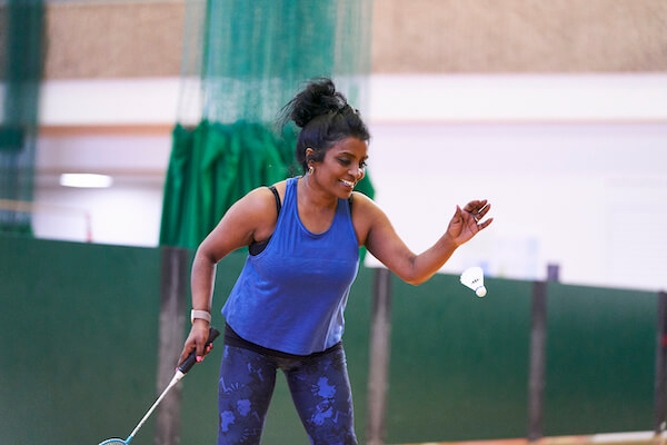 A woman playing badminton