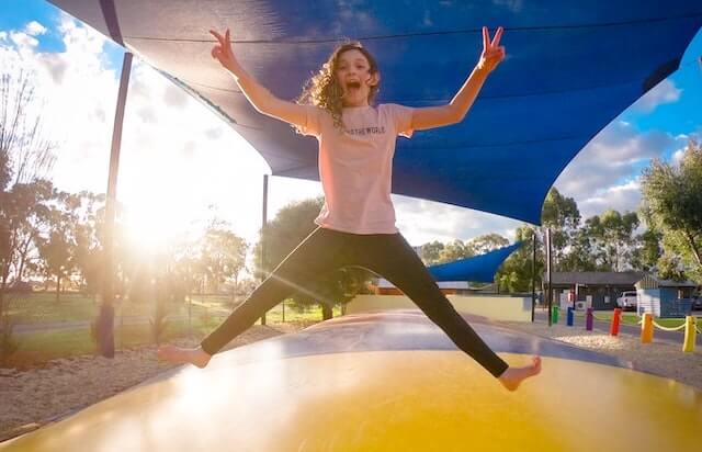 A girl on a jumping
pillow in a caravan park