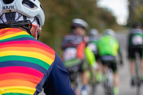 cyclist in rainbow cycling gear in a group