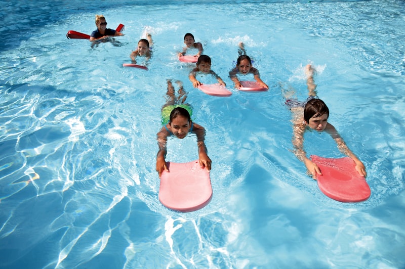 A group of children in an indoor swimming pool
