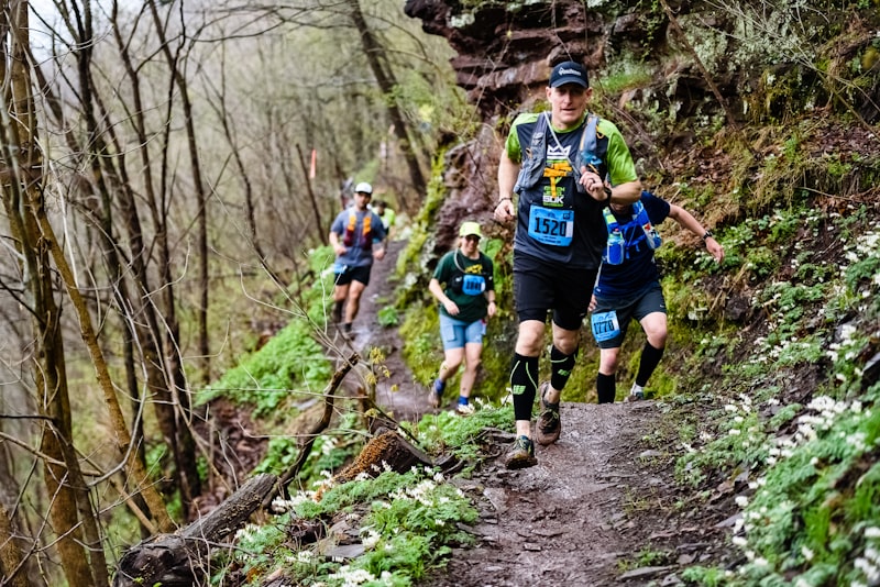Two runners on a forest trail during daytime