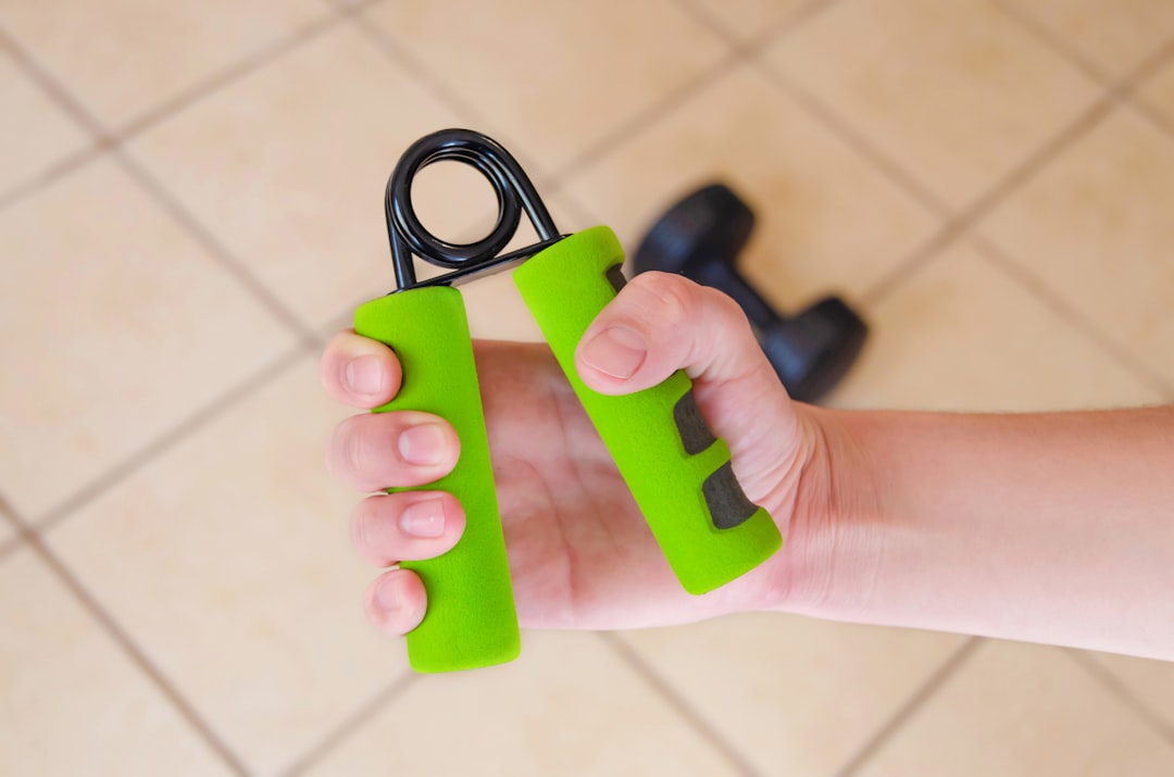 A person squeezing a hand grip strengthener