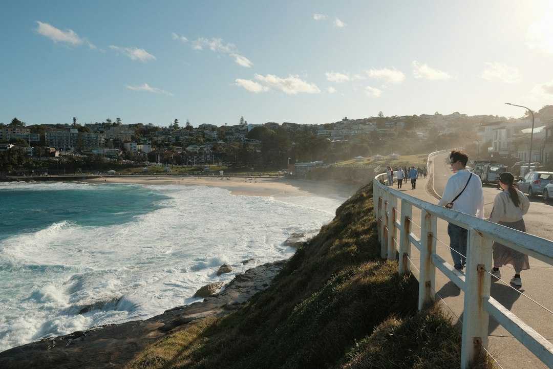 People walking along a coastal path near Tamarama in Sydney