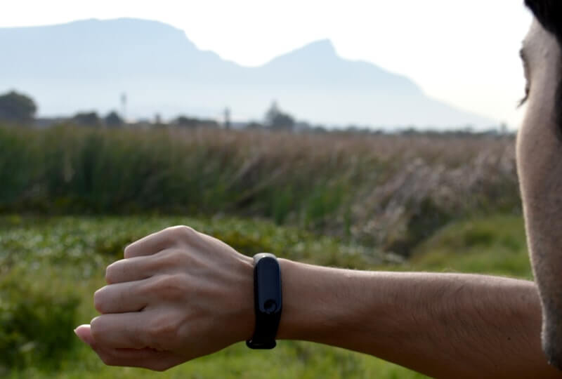 A person checking a fitness tracker outdoors