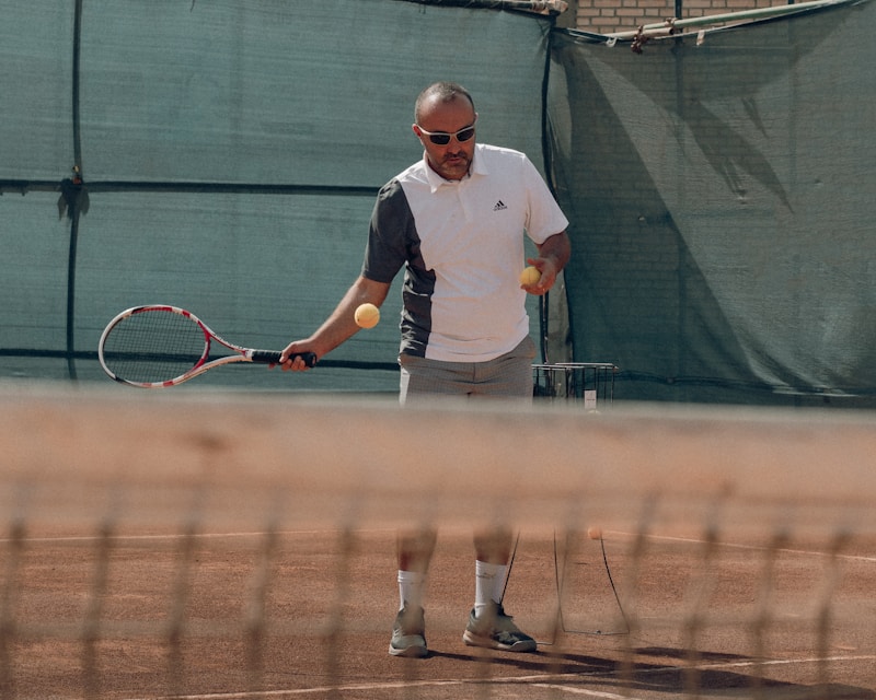 A man hitting a ball with a tennis racket at a social tennis session