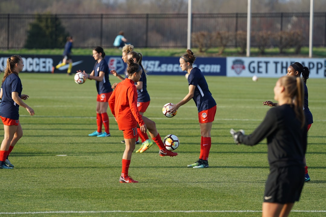 Group of women in football training warmup session on the pitch