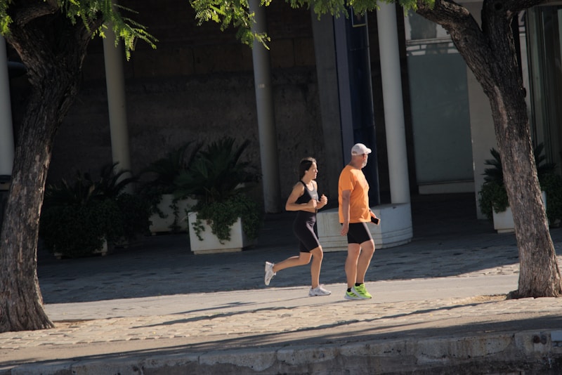 A man and woman running down a street together as part of a regular routine