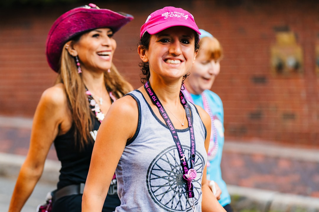 Women in pink at a community walk, walking together along a city street