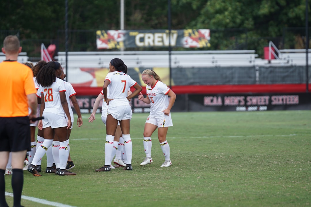 Group of women playing soccer together on a football field