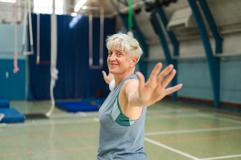 Older woman with short blonde hair exercising in a gym