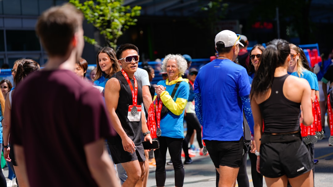 A casual group of adult runners chatting before an evening run in an inner-city Australian park