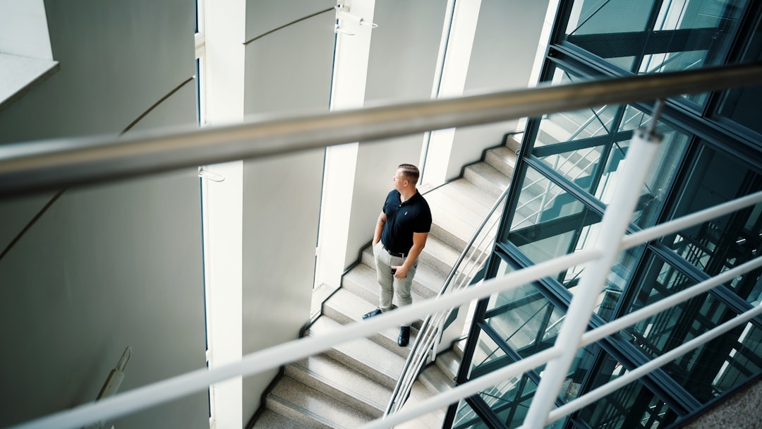 Office worker climbing a flight of stairs in business attire during a workday break