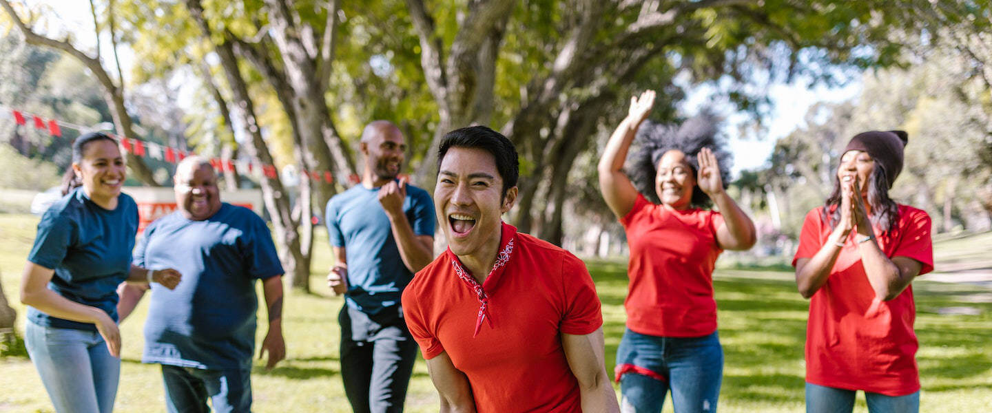 Group fitness class training together outdoors