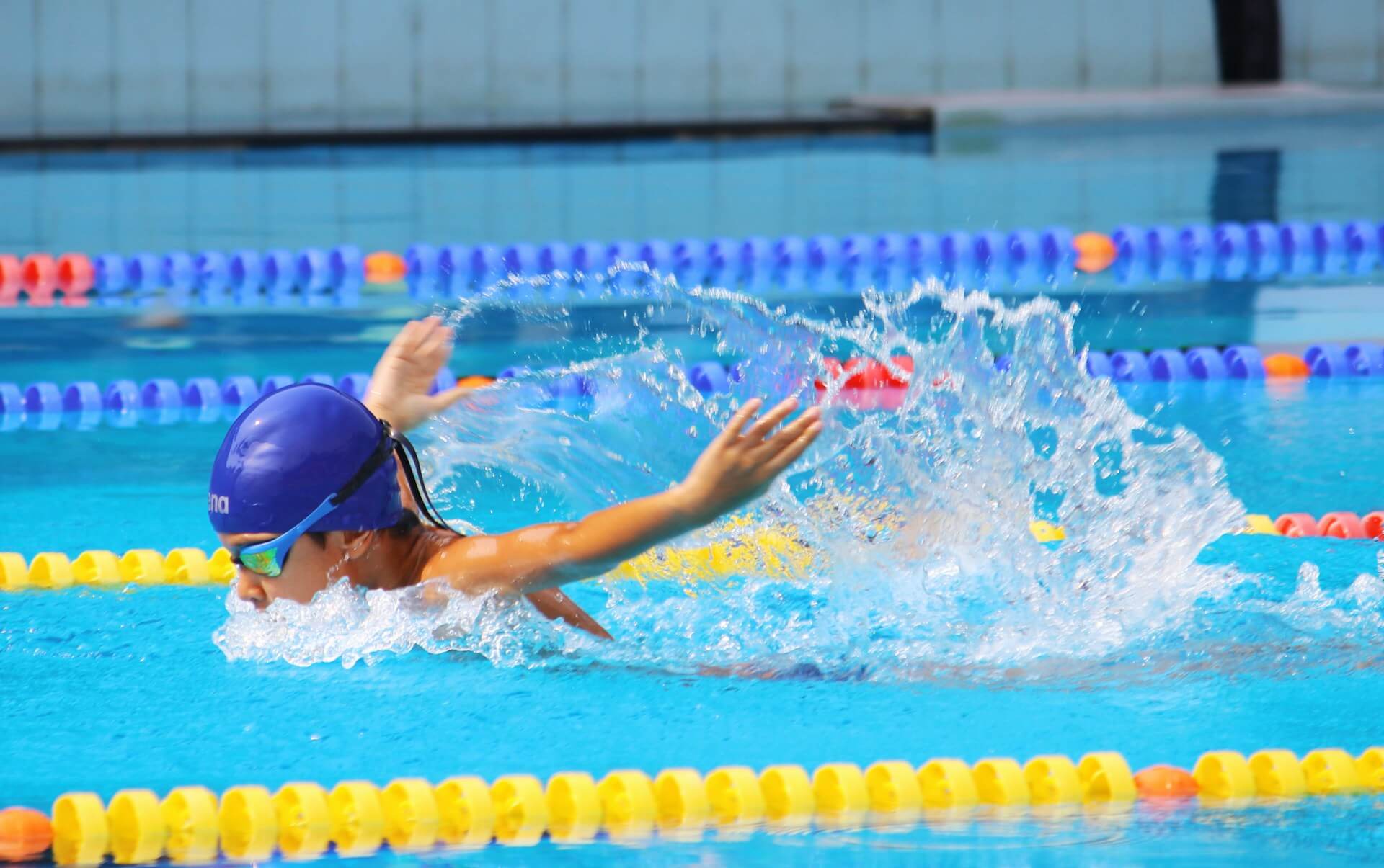 Swim coach teaching a learner in a pool