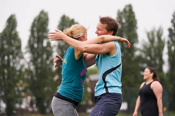 A group of women playing social sports in a park