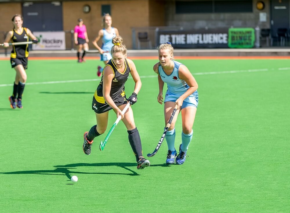 Hockey players competing in club uniforms