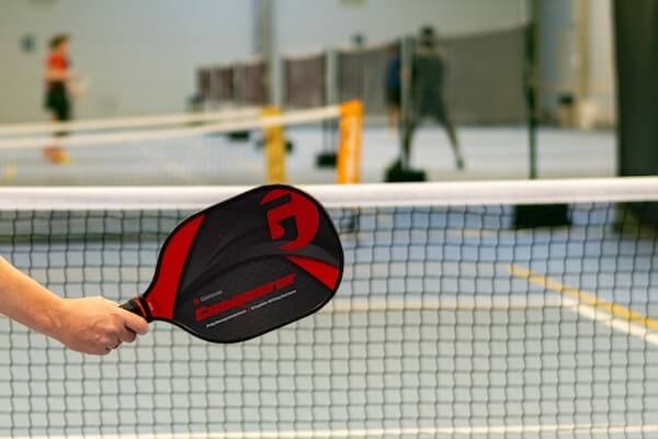 person with pickleball racquet on a court