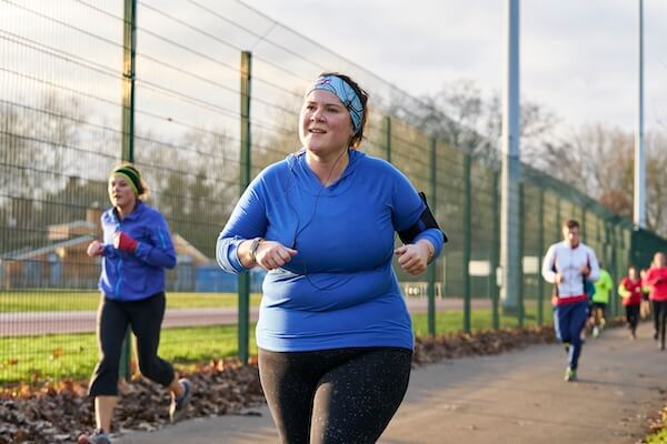 A group of adults running on an outdoor track