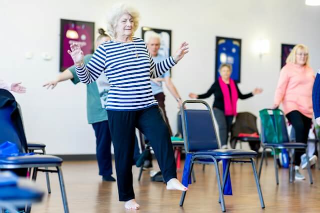 Older adults taking part in a gentle movement class