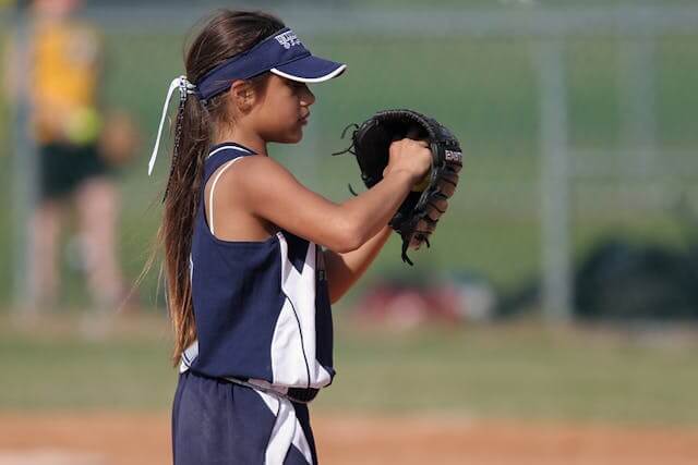 A girl getting ready to throw a softball